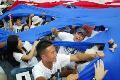 SKorean protesters tear apart a large USflag during protest near Yongsan US base