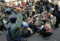 Dhaka. Riot policemen charge a group of activists