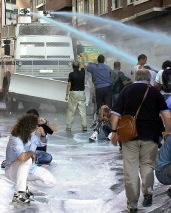 Police charging against demonstrators with water cannons