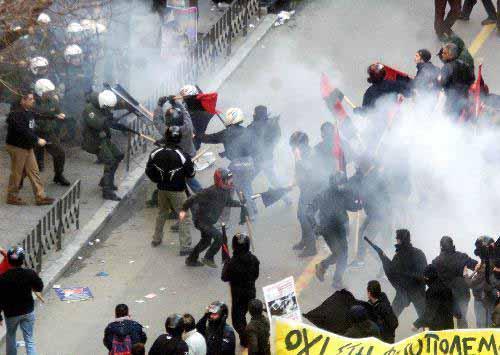 Protesters fight with riot police in front of the US consulate in Thessaloniki