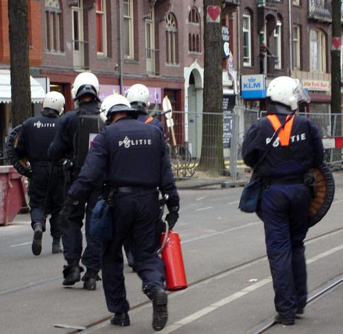 Police carrying tear gas canister