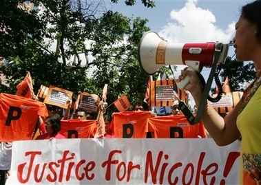 Protesters display placards during a rally across the U.S. Embassy in Manila 